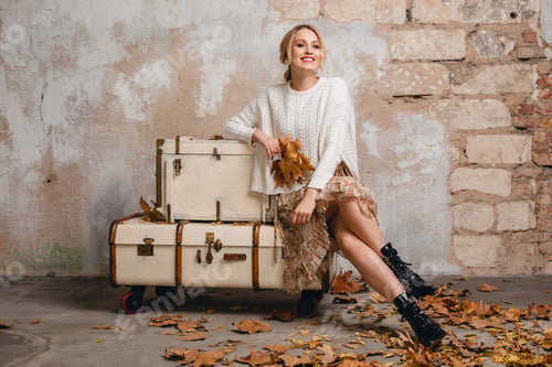 Preview: Stylish Woman Leans on Vintage Suitcases with Autumn Leaves