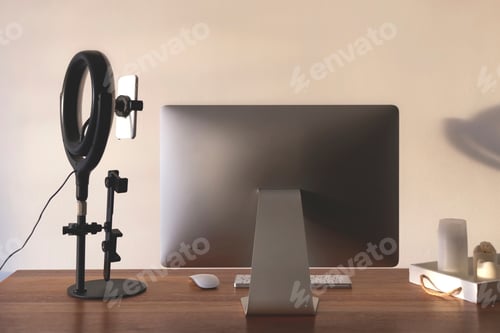 Preview: Ring lamp on blogger's desktop in home interior. Technical equipment for online promotion