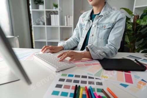 Preview: Graphic or UI designer work on computer laptop and with tablet after brainstorming unique design