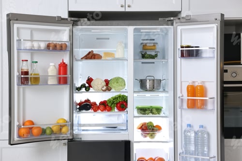 Preview: Open refrigerator full of different products in kitchen