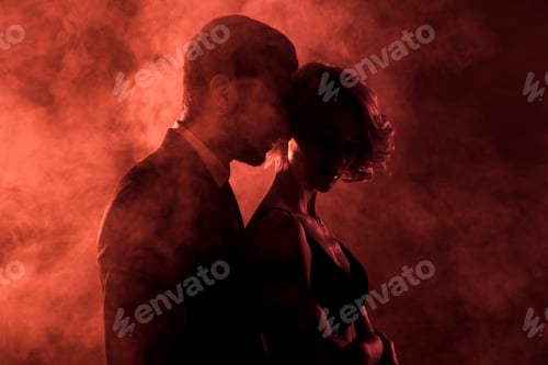 Preview: sensual man embracing passionate woman in smoke on red background