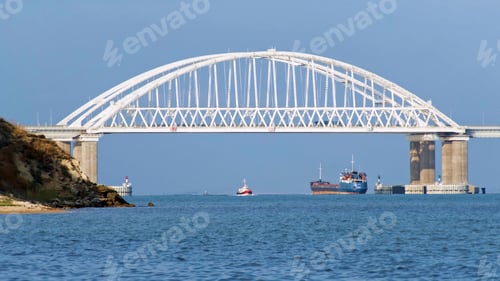 Preview: Breathtaking seascape with a white beautiful bridge with many moving cars above the water surface