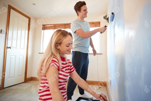 Preview: Couple Decorating Room In New Home Painting Wall Together