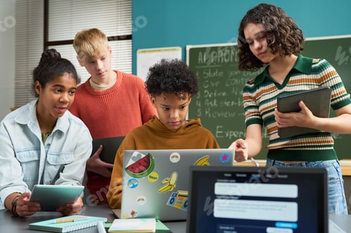 Preview: Diverse Teenagers Collaborating on Digital Project in Modern Classroom Setting