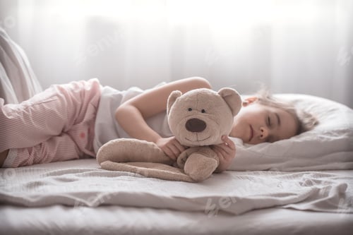 Preview: Little cute girl in bed with toy