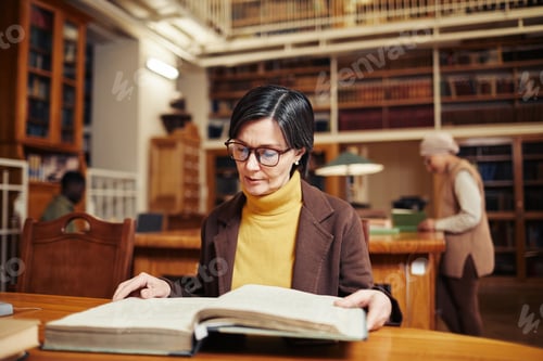 Preview: Woman Reading Book in Library