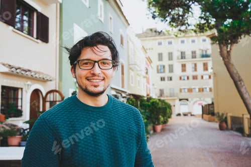 Preview: Smiling young man against a urban scene