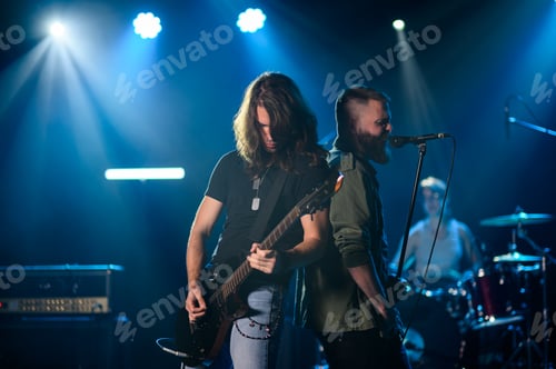 Preview: Rock band performing live on stage with guitarist and singer