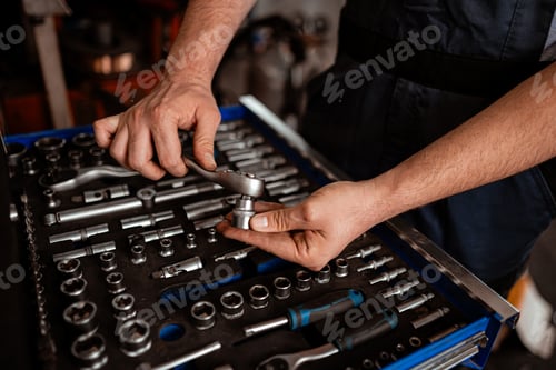 Preview: Person works with tools in a garage on a project late in the afternoon