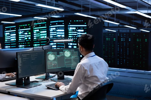 Preview: Employee inspecting data center equipment supporting worldwide network