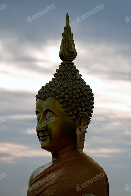 Preview: Vertical aerial view of the head of big golden Buddha statue on the top of a mountain