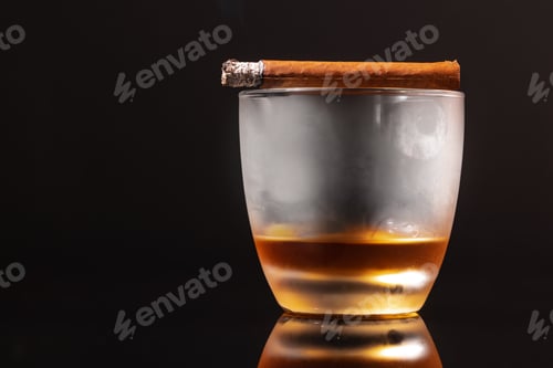 Preview: Burning cigar and glass of whisky on black background