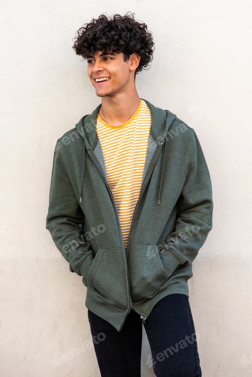 Preview: cool young male model smiling and posing by white wall