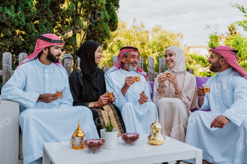 Preview: Middle eastern muslim family enjoying tea and togetherness outdoors