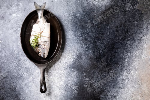 Preview: Fresh uncooked Dorado or sea bream fish in the pan