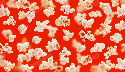 Preview: Delicious pop corn grains closeup on red background