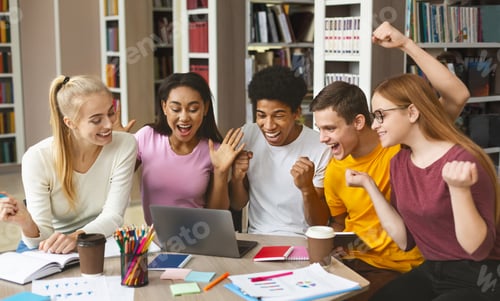 Preview: Group of young happy students enjoying test results in library