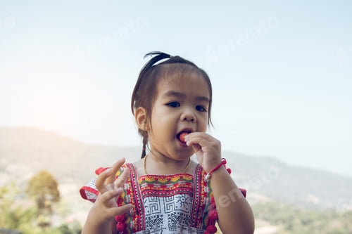 Preview: Girls children are enjoying eating strawberry with happy in garden.