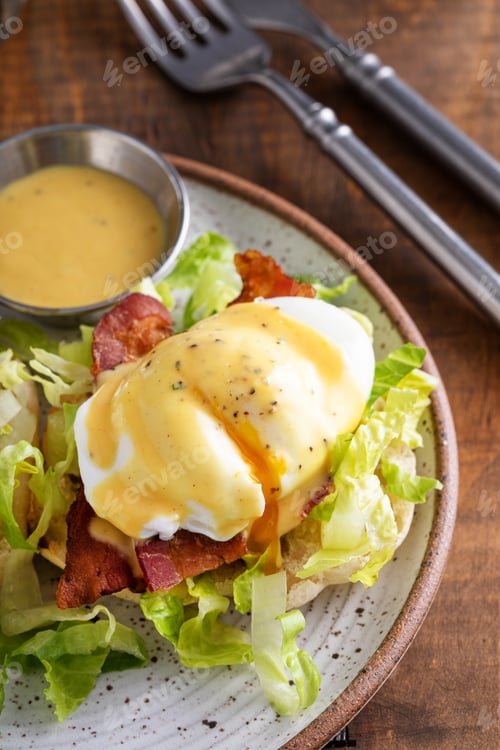 Preview: Egg benedict sandwich on english muffin with lettuce and bacon