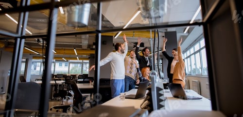 Preview: Happy young business people standing in the office and looking forward to success in the office