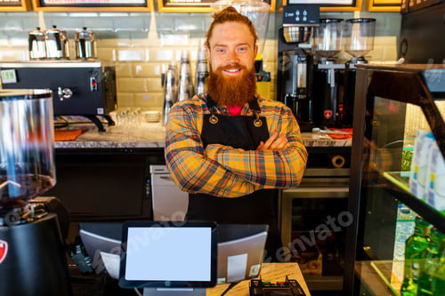 Preview: Professional barista young redhaired ginger bearded man in black apron working in coffee shop