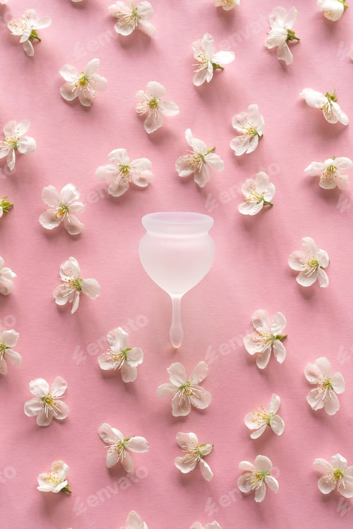 Preview: Silicone menstrual cup. Women's health and alternative hygiene. Cup with spring flowers