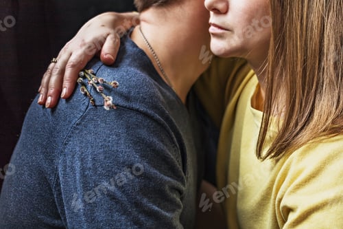 Preview: Close-up young couple in love in each other's arms on a black background.