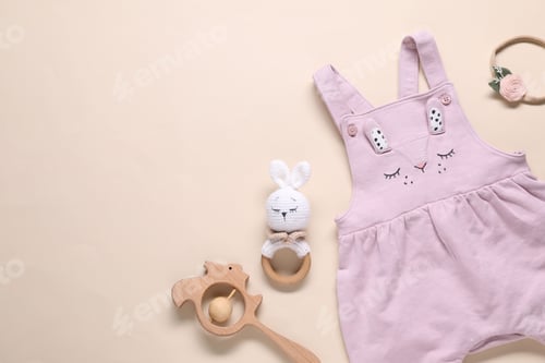 Preview: Baby jumpsuit and accessories on beige background, flat lay. Space for text