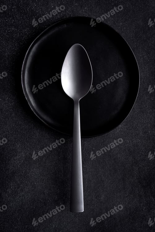 Preview: From above picture of composition of black dish and cutlery