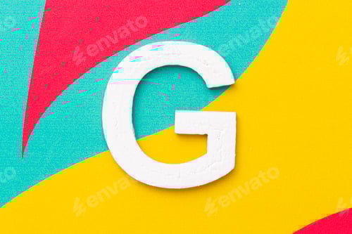 Preview: Letter G of the alphabet on colored background, top view