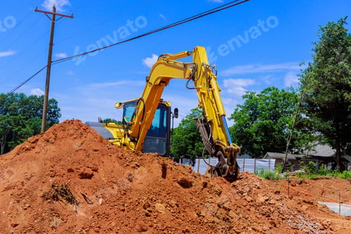 Preview: In sunshine, large construction excavator is observed on a construction site