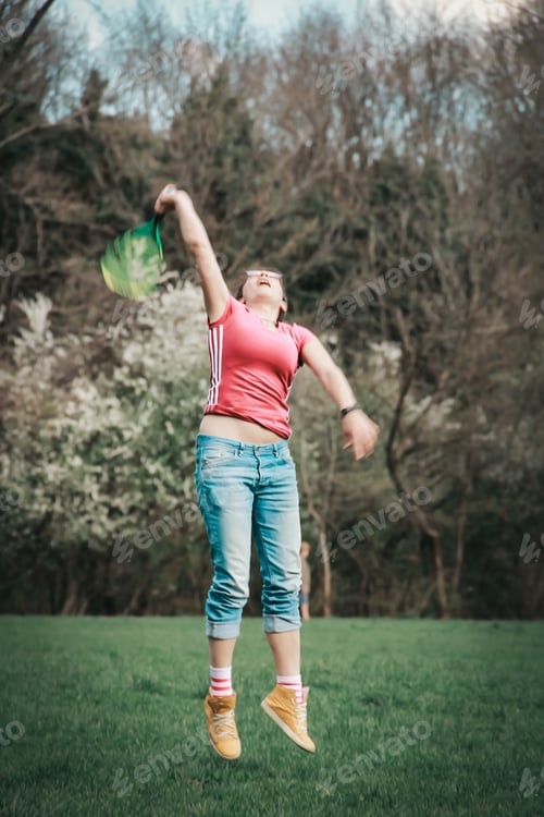 Preview: Woman playing badminton in the park