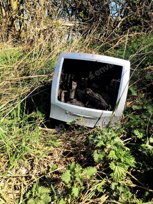 Preview: old technology out of date computer, TV dumped in wasteland in a fly tipping concept with copy space
