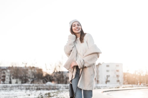 Preview: Smiling Woman Posing in Light Winter Fashion