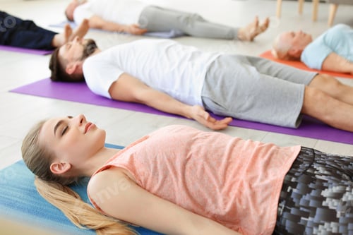 Preview: Group of people in sportswear practicing yoga indoors