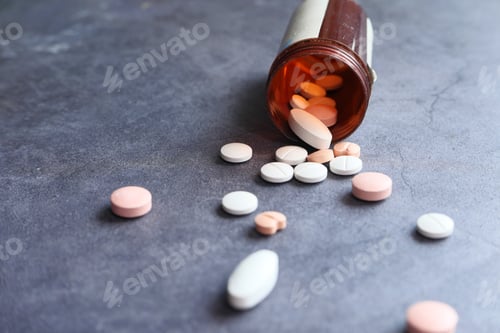 Preview: close up of colorful pills spilling from container