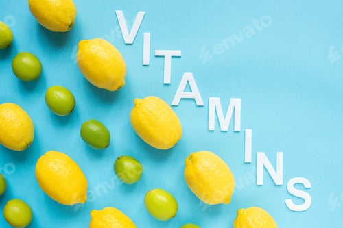 Preview: Flat Lay With Ripe Yellow Lemons, Green Limes And Word Vitamins on Blue Background