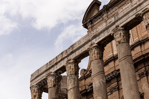Preview: ROME, ITALY - JUNE 28, 2019: temple of Antoninus and Faustina under blue sky
