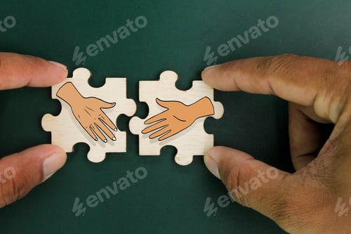 Preview: wooden puzzle with two shaking hands icons. the concept of deal or agreement.
