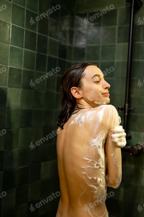 Preview: Woman taking shower and soaping the body with shower gel
