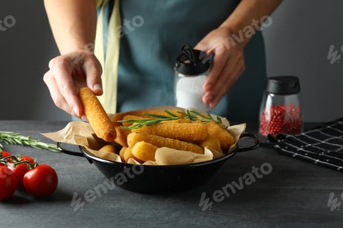 Preview: Concept of cooking cheese sticks on dark table