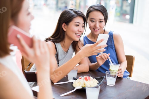 Preview: Best female friends sitting at sidewalk café