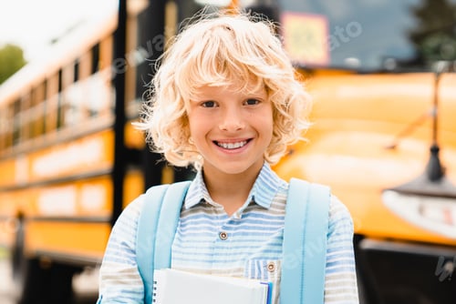 Preview: Caucasian schoolboy pupil going back to school with books and copybooks on school bus