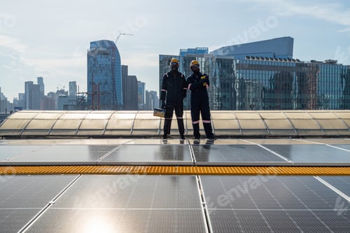 Preview: Engineers and technicians check drawings for installing solar cell panels on the roof.