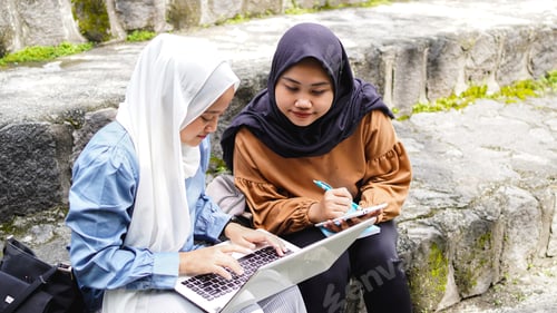 Preview: two Asian woman student friends discussing