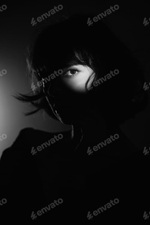 Preview: Studio shot of a young woman in a ray of light.