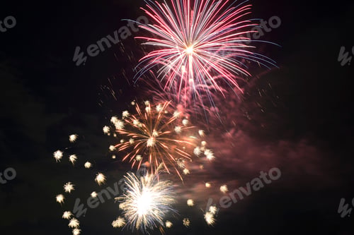 Preview: Aerial view of bright fireworks exploding with colorful lights against dark night sky on US