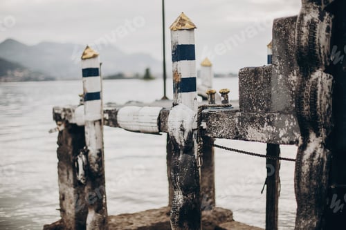 Preview: Beautiful old wooden dock with aged columns in white and blue colors