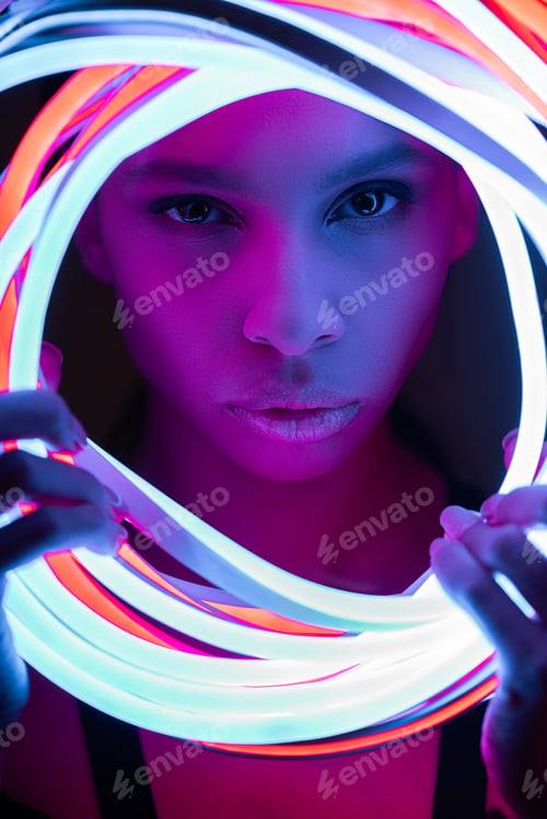 Preview: portrait of futuristic african american woman in neon lighting