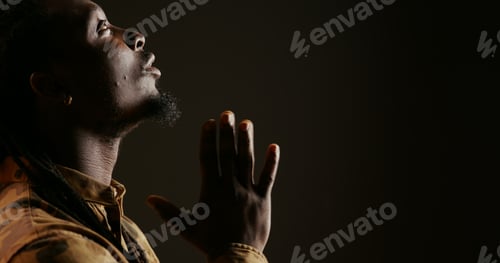 Preview: Religious adult believing in Jesus and praying in studio